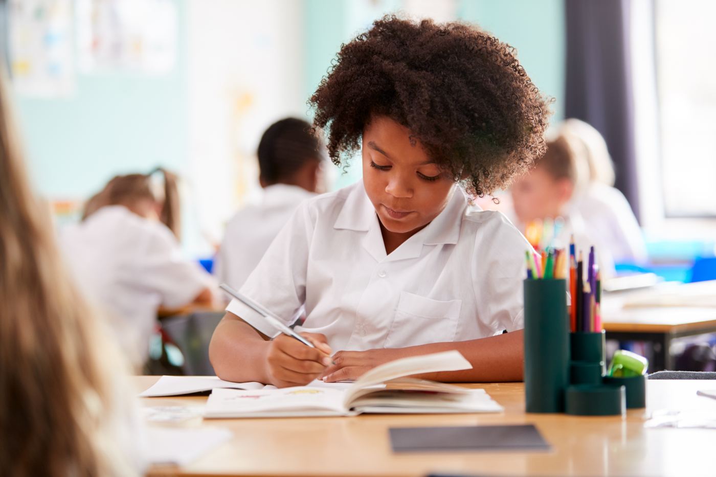 Child writing during a tuition session